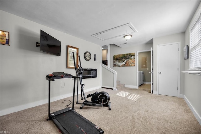 workout room with attic access, baseboards, carpet floors, and washer / dryer