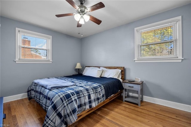 bedroom featuring hardwood / wood-style floors, baseboards, and ceiling fan