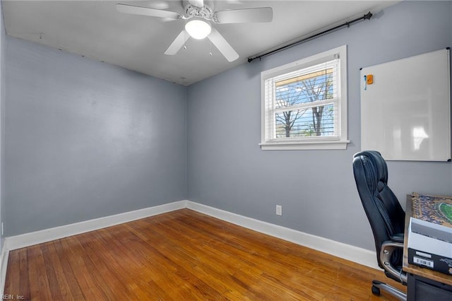 office featuring ceiling fan, baseboards, and wood finished floors