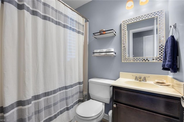 bathroom featuring a shower with curtain, toilet, and vanity