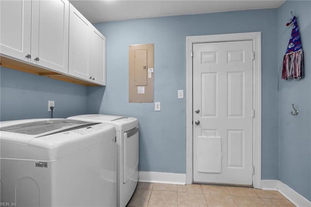 washroom featuring baseboards, electric panel, light tile patterned floors, cabinet space, and separate washer and dryer