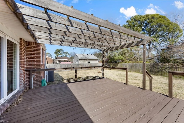 wooden deck with a pergola and a fenced backyard