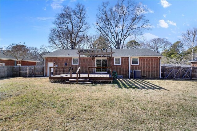 rear view of house with a lawn, a pergola, a fenced backyard, a wooden deck, and brick siding