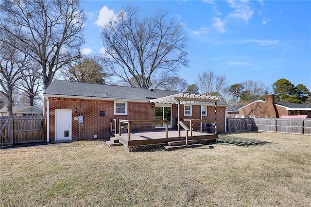 rear view of house with brick siding, a yard, a fenced backyard, and a pergola