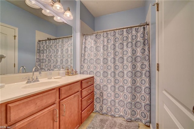 full bathroom featuring curtained shower, vanity, and tile patterned flooring