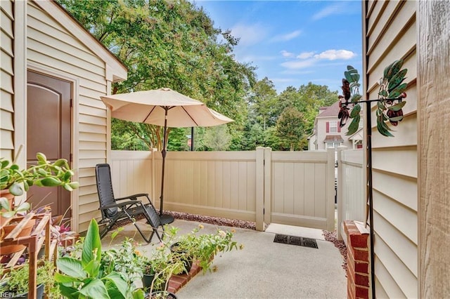 view of patio featuring a gate and fence