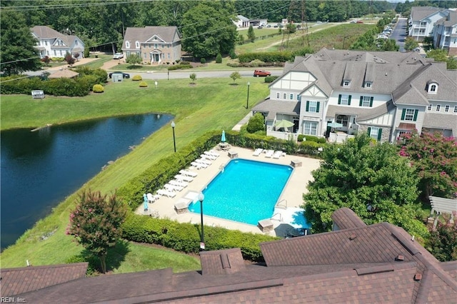 community pool featuring a patio area and a water view