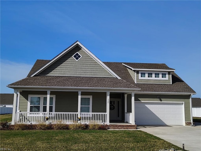 124 Savannah Ave, Grandy, NC 27939 - view of front of house with roof with shingles, a porch, an attached garage, concrete driveway, and a front lawn