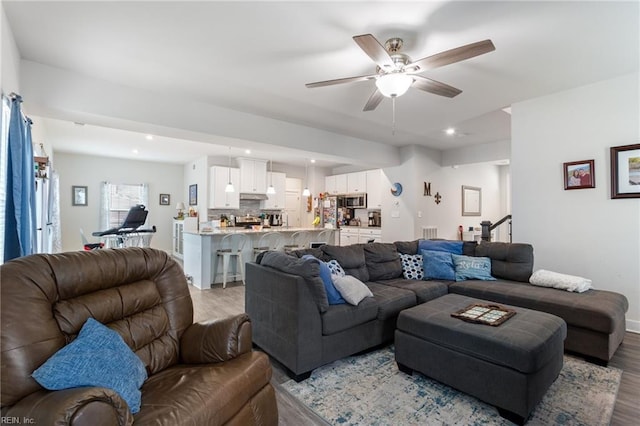 living room with recessed lighting, baseboards, ceiling fan, and light wood finished floors