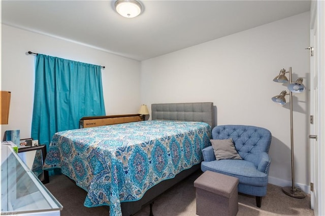 carpeted bedroom featuring baseboards