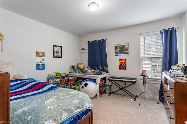 bedroom featuring baseboards and light carpet