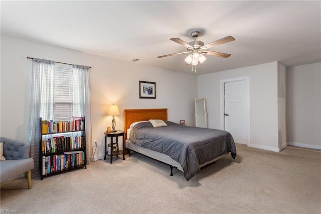 bedroom with baseboards, light carpet, and ceiling fan