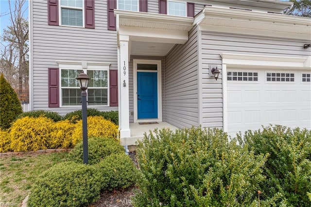 view of exterior entry with a garage