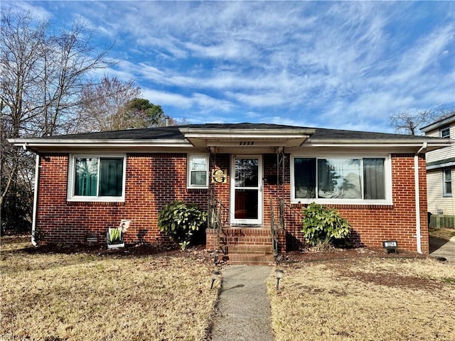 bungalow-style house featuring brick siding and crawl space