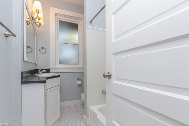 full bath featuring toilet, a tub, baseboards, walk in shower, and vanity