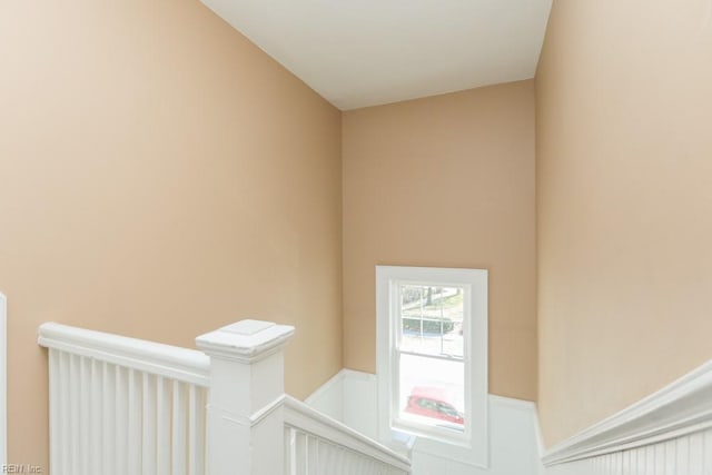 stairway featuring wainscoting