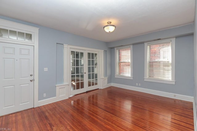 interior space featuring french doors, baseboards, and hardwood / wood-style floors