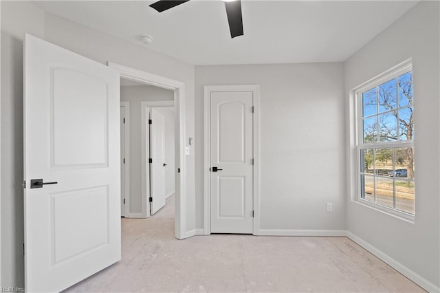 unfurnished bedroom with baseboards and ceiling fan