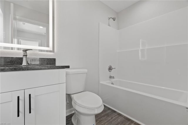 full bath featuring vanity, bathing tub / shower combination, toilet, and wood finished floors