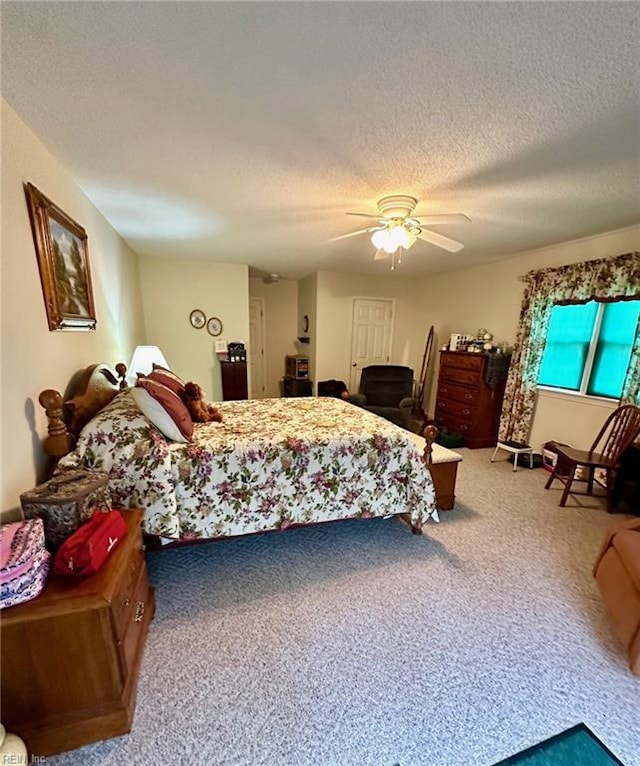 carpeted bedroom featuring a textured ceiling and a ceiling fan