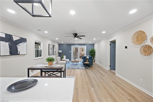 living area featuring ornamental molding, a ceiling fan, recessed lighting, light wood finished floors, and baseboards