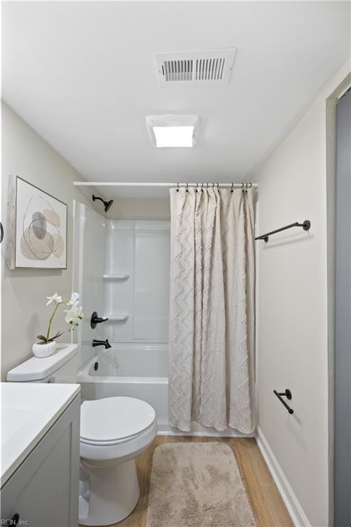 bathroom with vanity, wood finished floors, shower / bathtub combination with curtain, visible vents, and toilet