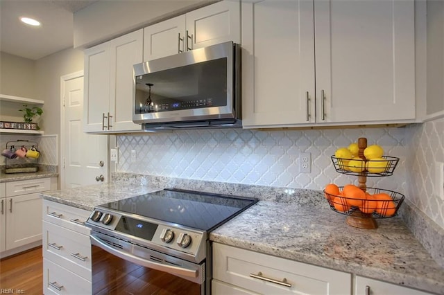 kitchen featuring white cabinetry, open shelves, light wood-style floors, and stainless steel appliances