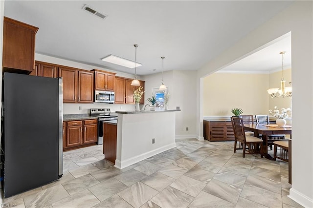 kitchen featuring visible vents, an inviting chandelier, appliances with stainless steel finishes, brown cabinetry, and hanging light fixtures