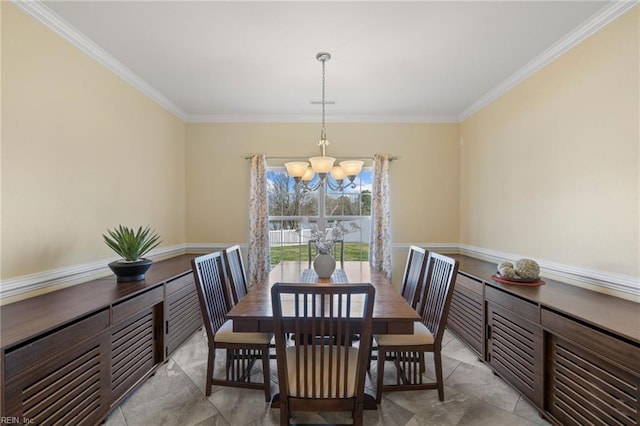 dining area with crown molding and a chandelier