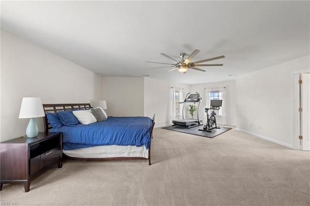 bedroom featuring a ceiling fan, baseboards, and light carpet