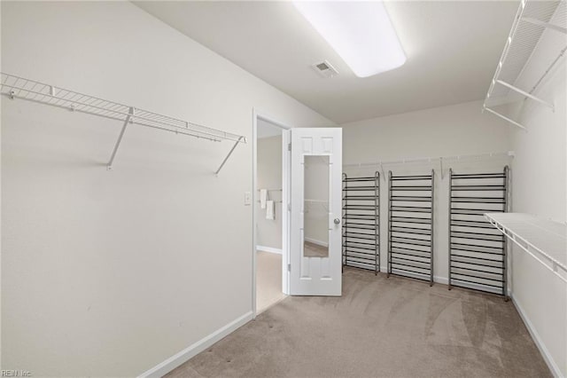 walk in closet featuring carpet and visible vents