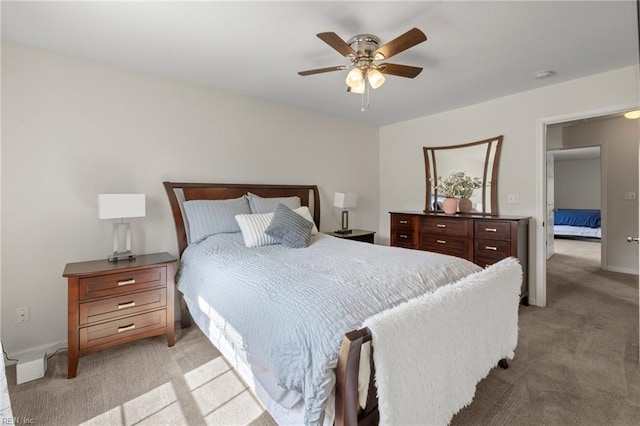 bedroom featuring light colored carpet and ceiling fan