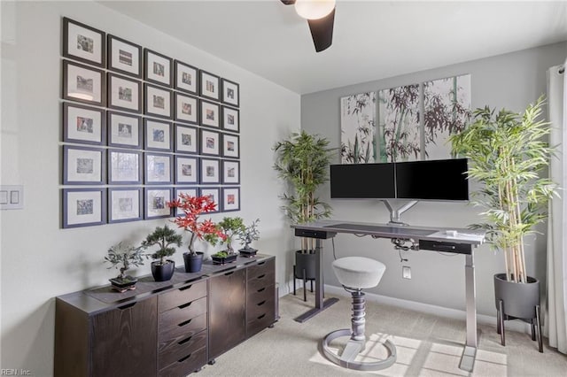 office space with baseboards, light colored carpet, and a ceiling fan