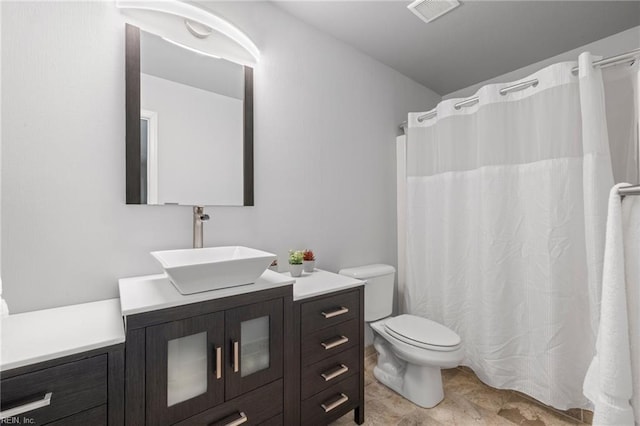 full bathroom featuring vanity, toilet, and visible vents