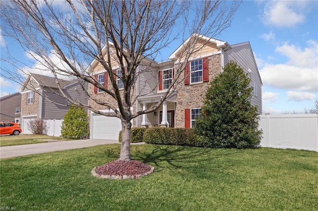 traditional-style house featuring a front lawn, stone siding, fence, concrete driveway, and an attached garage