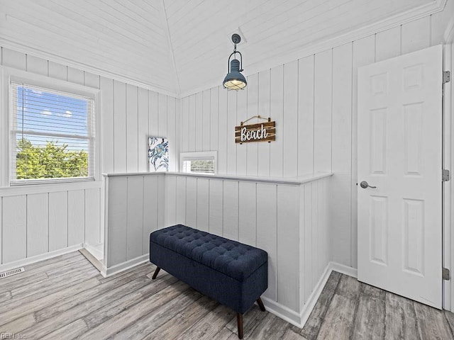 sitting room with visible vents, baseboards, and wood finished floors