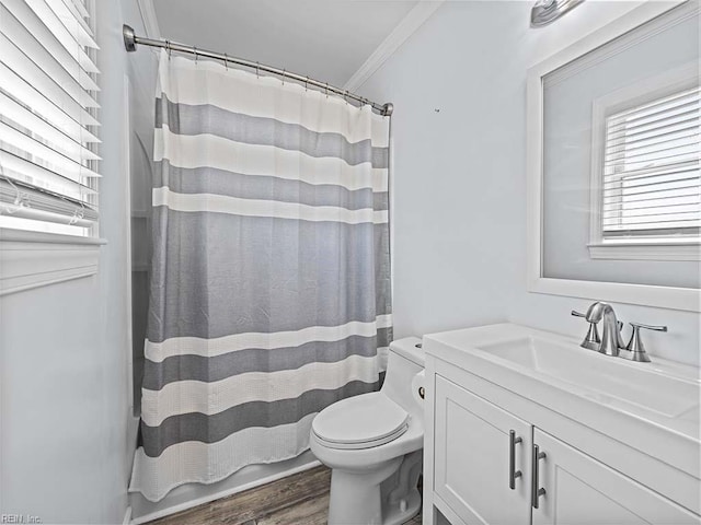 bathroom with crown molding, toilet, a shower with shower curtain, wood finished floors, and vanity