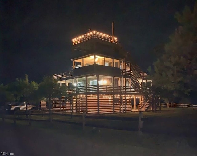 property at night featuring stairway