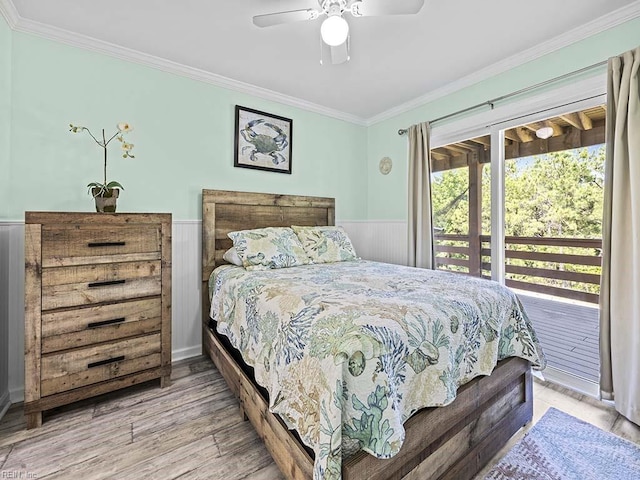 bedroom featuring crown molding, wainscoting, wood finished floors, a ceiling fan, and access to outside