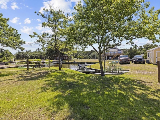 view of yard featuring a dock and a water view