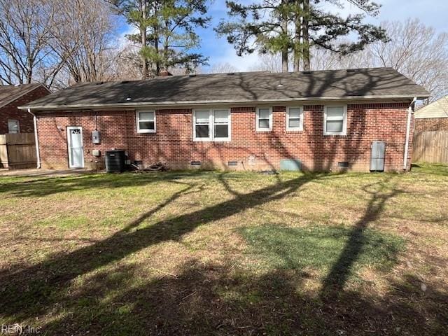 back of house featuring fence, a yard, crawl space, brick siding, and central AC unit