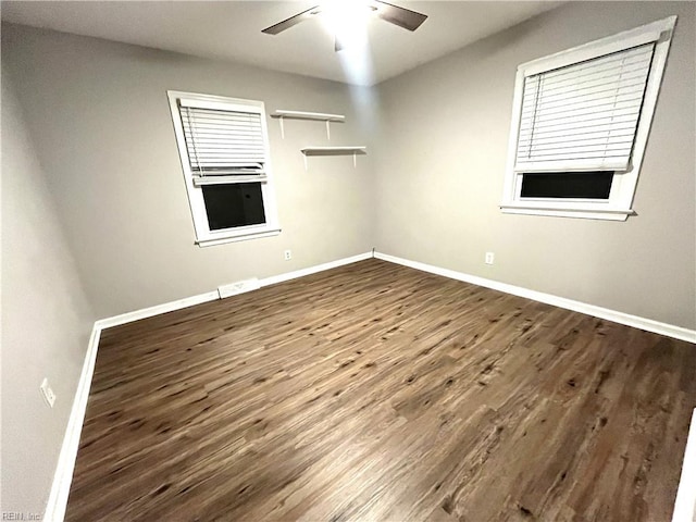 empty room with wood finished floors, baseboards, and ceiling fan