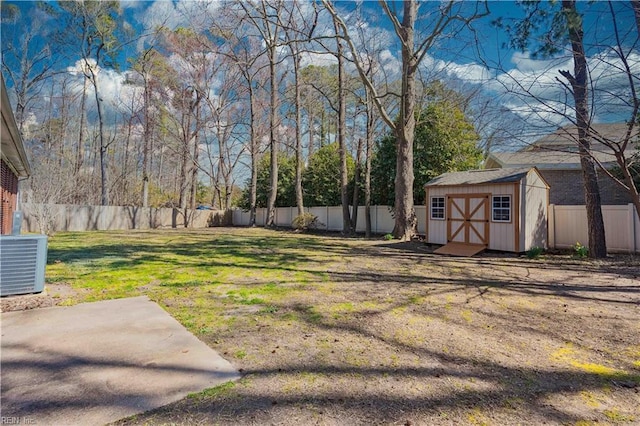 view of yard with a fenced backyard, central AC, an outdoor structure, and a shed