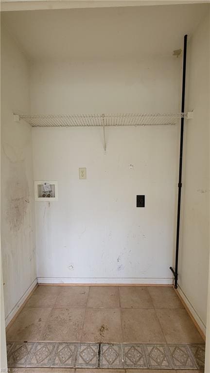 clothes washing area with washer hookup, laundry area, baseboards, and hookup for an electric dryer