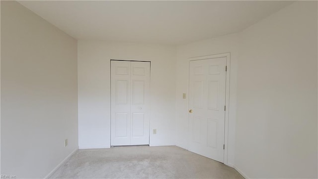 unfurnished bedroom featuring a closet and baseboards