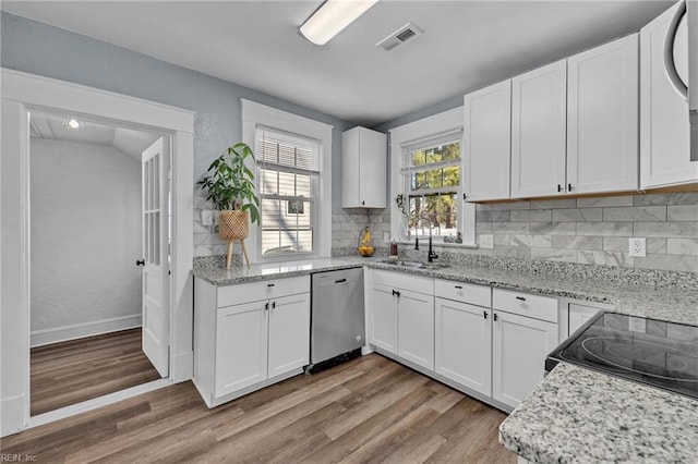 kitchen with dishwasher, light wood-style floors, visible vents, and a sink