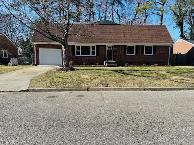 single story home featuring concrete driveway, a garage, brick siding, and a front yard