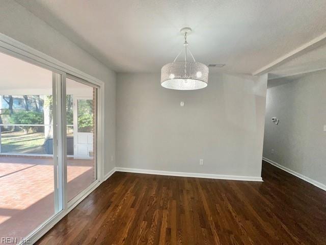 empty room with baseboards, an inviting chandelier, and dark wood-style flooring