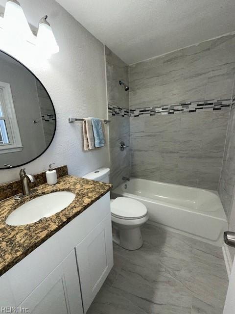 bathroom with vanity, toilet, and washtub / shower combination