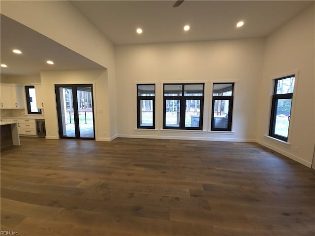 interior space with recessed lighting, french doors, baseboards, and dark wood-style flooring